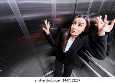 young scared businesswoman suffering from claustrophobia in elevator