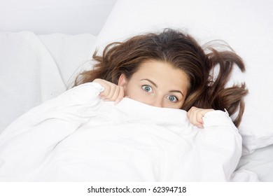 Young Scared Woman In Bed