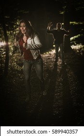 Young Scared Woman Running Through The Forest At Night In White Dress And Running Away From Man.