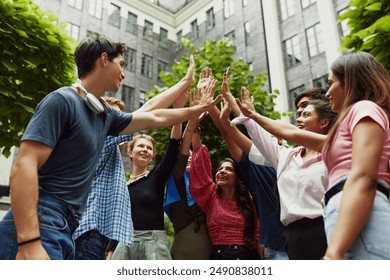 Young scholars, students from different countries enjoying finished study session outdoors, giving high five and celebrating successful pass of exams. Concept of education, university, multicultural - Powered by Shutterstock