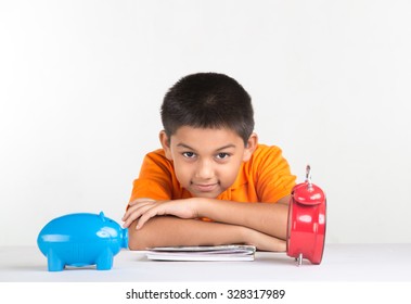 Young School Boy And Sitting At Desk