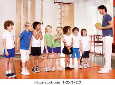 Young Schoolchildren And Gym Teacher At School