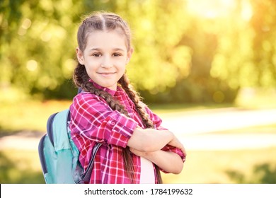 Young schoolgirl with backpack. Lifestyle going to classroom. Outdoor autumn park. Children learn smart. Street student. Happy preschool kid. Back to school