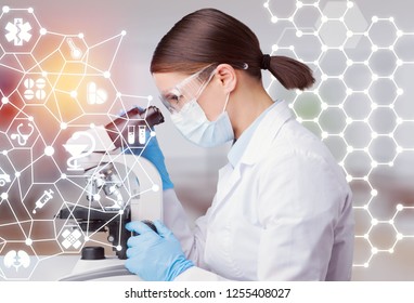 Young scientist looking through a microscope in a laboratory. Young scientist doing some research.