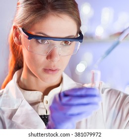 Young Scientist Pipetting In Life Science Laboratory.