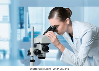 young scientist work with a microscope in modern lab.