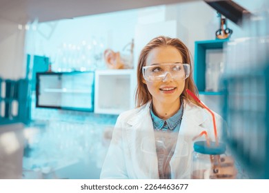 Young Scientist Working in The Laboratory. Scientist in lab doing research and using lab machines, test tubes, microscope and every laboratory equipment. Scientists in laboratory working on research
