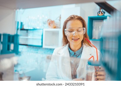 Young Scientist Working in The Laboratory. Scientist in lab doing research and using lab machines, test tubes, microscope and every laboratory equipment. Scientists in laboratory working on research