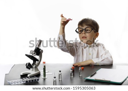 Similar – Image, Stock Photo boy is making science experiments in a laboratory