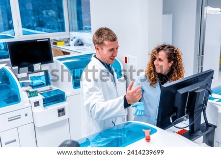 Young scientists working using computer in a modern laboratory of an hospital in the pathology area