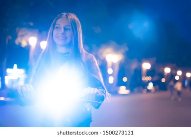 Young Scooter Girl In Park At Night