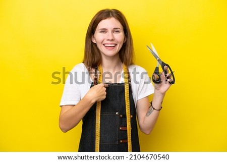 Young seamstress English woman isolated on yellow background with surprise facial expression