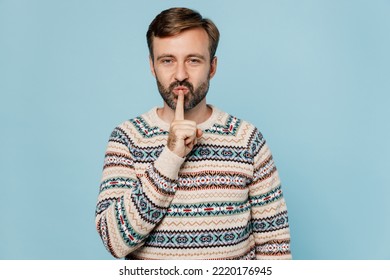 Young Secret Caucasian Man 30s Wear Sweater Say Hush Be Quiet With Finger On Lips Shhh Gesture Look Camera Isolated On Plain Pastel Light Blue Cyan Background Studio Portrait. People Lifestyle Concept