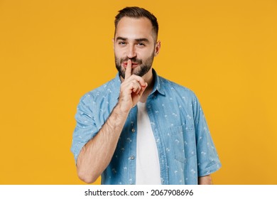 Young Secret Fun Smiling Happy Caucasian Man 20s Wearing Blue Shirt Say Hush Be Quiet With Finger On Lips Shhh Gesture Isolated On Plain Yellow Background Studio Portrait. People Lifestyle Concept.