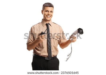 Young security guard holding a walkie talkie and a surveillance camera isolated on white background