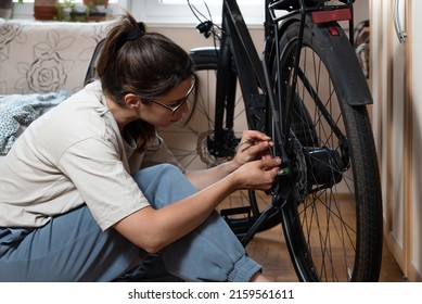 Young Self Learned Woman Or Girl Mechanic Fixing And Repairing Her Bicycle At Her Home. Female Repair Chain On Rear Wheel Before She Start To Ride A Bike On Nice Sunny Weather. 