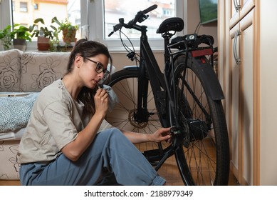 Young Self Learned Woman Or Girl Mechanic Fixing And Repairing Her Bicycle At Her Home. Female Repair Chain On Rear Wheel Before She Start To Ride A Bike On Nice Sunny Weather.