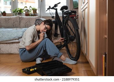 Young Self Learned Woman Or Girl Mechanic Fixing And Repairing Her Bicycle At Her Home. Female Repair Chain On Rear Wheel Before She Start To Ride A Bike On Nice Sunny Weather.