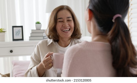 Young senior citizen authentic real family sit talk to grown up children kid with love share moment at home living room feeling positive relax enjoy listen to child girl. Parent coach communication.