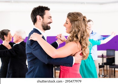 Young And Senior Couples Getting Dance Lessons