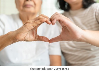 Young And Senior Woman Doing Heart Sign By Their Hands Togetherness Concept. Elderly Care And Protection With Love From Grandchild. 