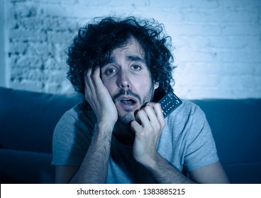 Young Sensitive Man Hocked Watching Romantic Movie On TV Alone At Home Late At Night. Millennial Guy Enjoying Love Story Film On Internet. In Real Men Are Vulnerable And Braking Gender Roles Concept.