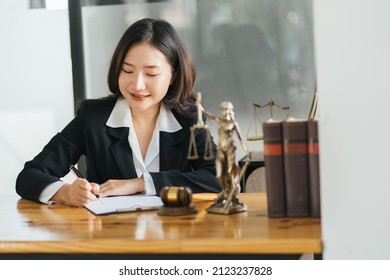 Young Serious Asian Female Ceo Lawyer Businesswoman Sitting At Desk Working Typing On Laptop Computer In Contemporary Corporation Office. Business Technologies Concept.