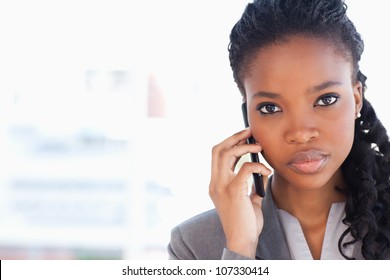 Young Serious Businesswoman Looking Straight Ahead While Talking On The Phone