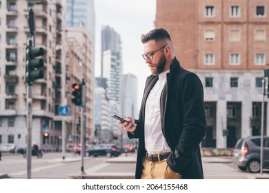 Young Serious Caucasian Businessman Outdoor Walking Using Smartphone Browsing Internet 5g Technology, Watching Video Streaming Or Playing Games