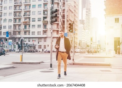 Young Serious Caucasian Businessman Outdoor Walking Using Smartphone Browsing Internet 5g Technology, Watching Video Streaming Or Playing Games