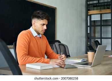 Young Serious Concentrated Hispanic Indian Latin High School Student Gen Z Hipster Having Virtual Distant Class Course Writing Notes Using Laptop Pc Computer. Education Technologies Concept.