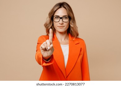 Young serious confident employee business woman corporate lawyer 30s wearing classic formal orange suit glasses working in office warning raise up forefinger isolated on plain beige background studio - Shutterstock ID 2270813077