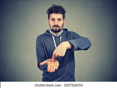 Young Serious Hipster Man Asking For More Money To Pay Back Debt