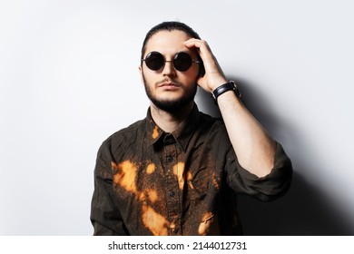 Young Serious Man Wearing Round Sunglasses, White Background.