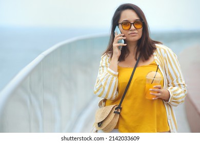 Young Serious Overweight Brunette Woman 30-35 Years Old Talking On A Mobile Phone With Negative Emotion. Bad News On Phone.