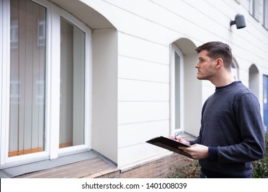 Young Service Man Examining Closed Door At The Entrance - Shutterstock ID 1401008039