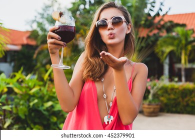 Young Sexy Beautiful Woman Holding A Glass Of Sangria Drink, Summer Vacation, Resort Style, Tropical Hotel, Pink Blouse, Sunglasses, Kiss, Wine