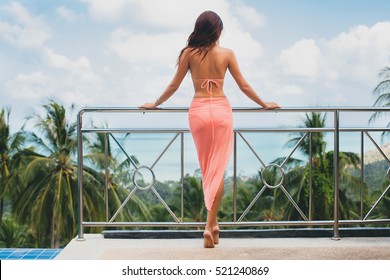 Young  Sexy Beautiful Woman In Pink Bikini, Posing On Terrace Of Resort Hotel, Slim, Tanned Skin, Fashion Glamour Accessories, Relaxed, Sensual, Summer Vacation, View From Back