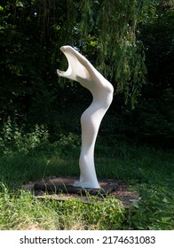 young sexy elegant woman, her body wrapped in long skin tight white dress highlighting body shapes, as living statue on pedestal in nature, copy space