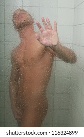 Young sexy man taking shower