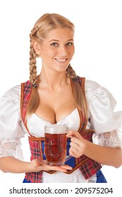 Young sexy Oktoberfest woman wearing a traditional Bavarian dress dirndl serving beer mugs