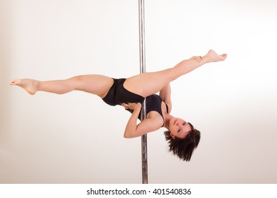 Young sexy pole dancer on white background