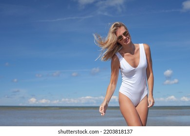 Young Sexy Slim Woman In White Bodysuit