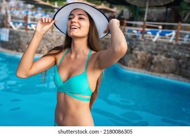 Young sexy woman in bikini enjoying summer vacation on beach. People travel happiness concept.