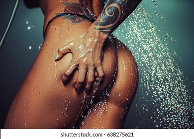 Young Sexy Woman Butt With Raining Water. Tattoo On Body.