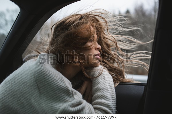 young sexy woman in the car, thinking, chilling.\
Adventure mood