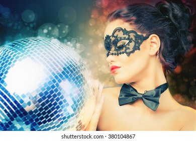 Young Sexy Woman In Carnival Mask Keeping Disco Ball. Party. Night Club. Fashion. Venetian Carnival.