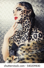 young sexy woman with leopard make up all over body, cat bodyart