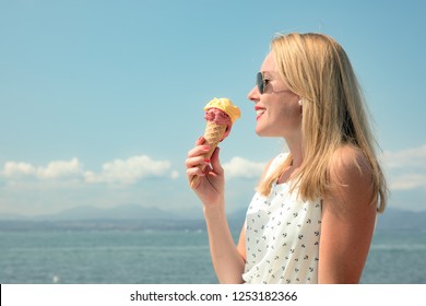 Busty girl selling ice-creams on the beach