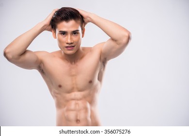 Young shirtless Asian man with perfect torso